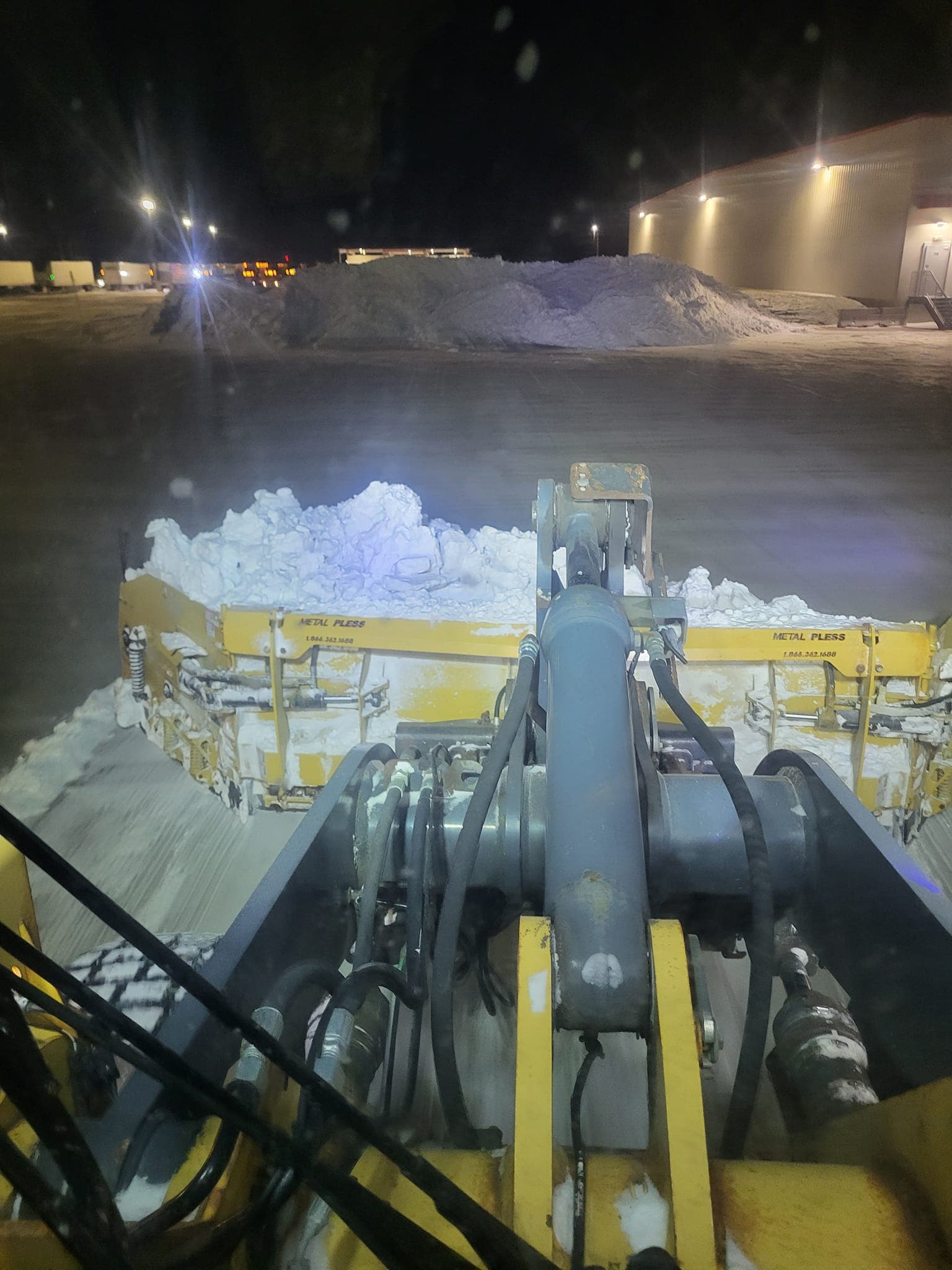 Commercial snow removal truck clearing parking lot in Owatonna, Minnesota